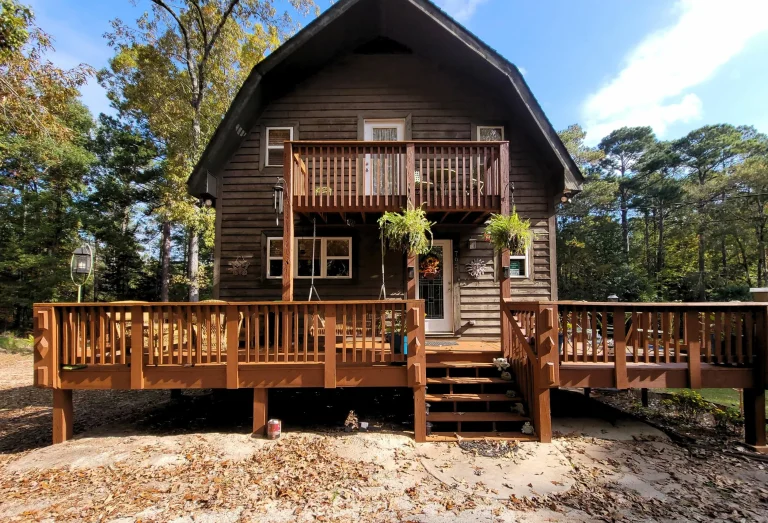 Stained wood siding and deck on a house surrounded by trees